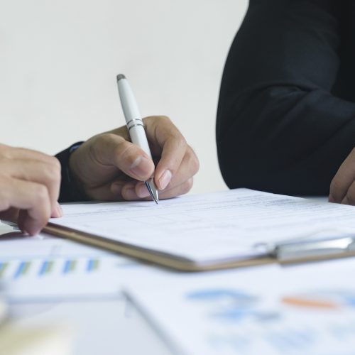 Business man sign a contract investment professional document agreement, ready signing profitable offer agreement after checking contract terms of conditions, executive manager involved in legal paperwork.